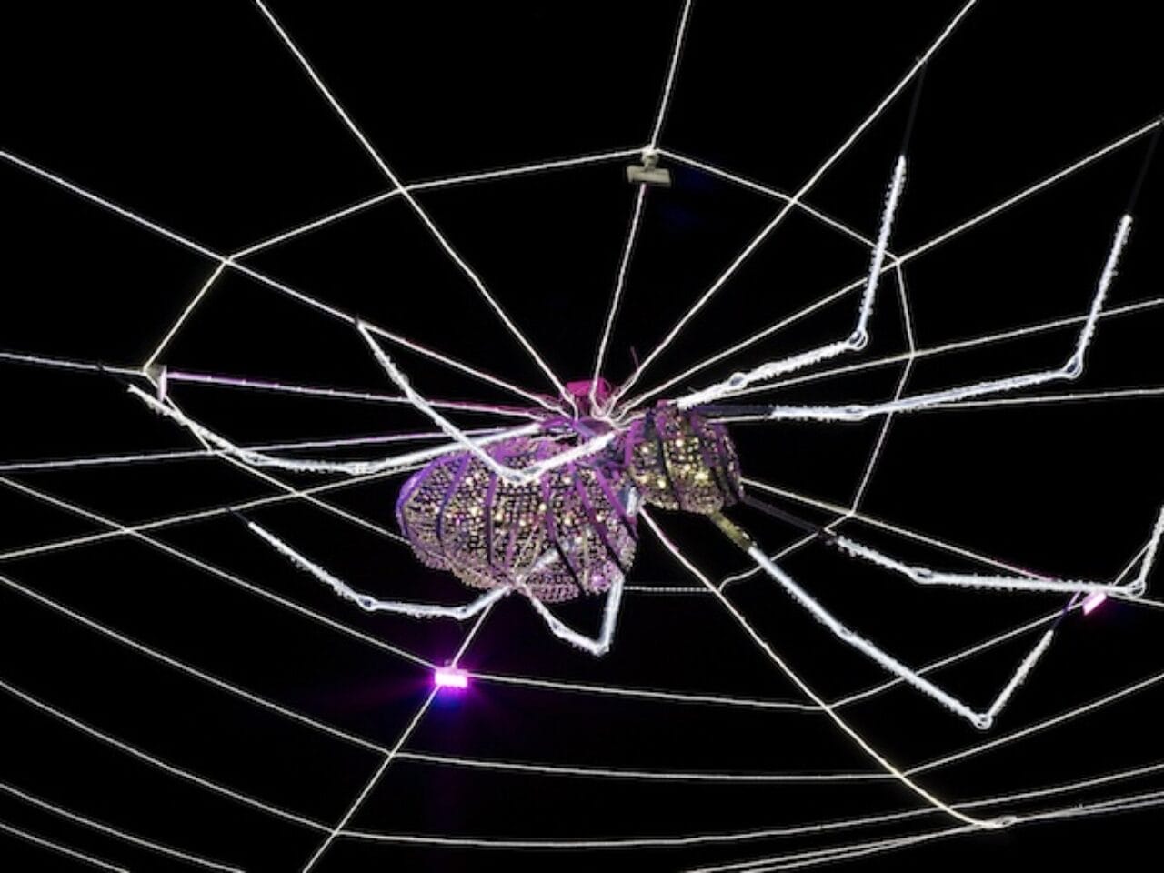 A close up of a giant crystal-studded spider, hanging above the centre of Liverpool's Exchange Flags.