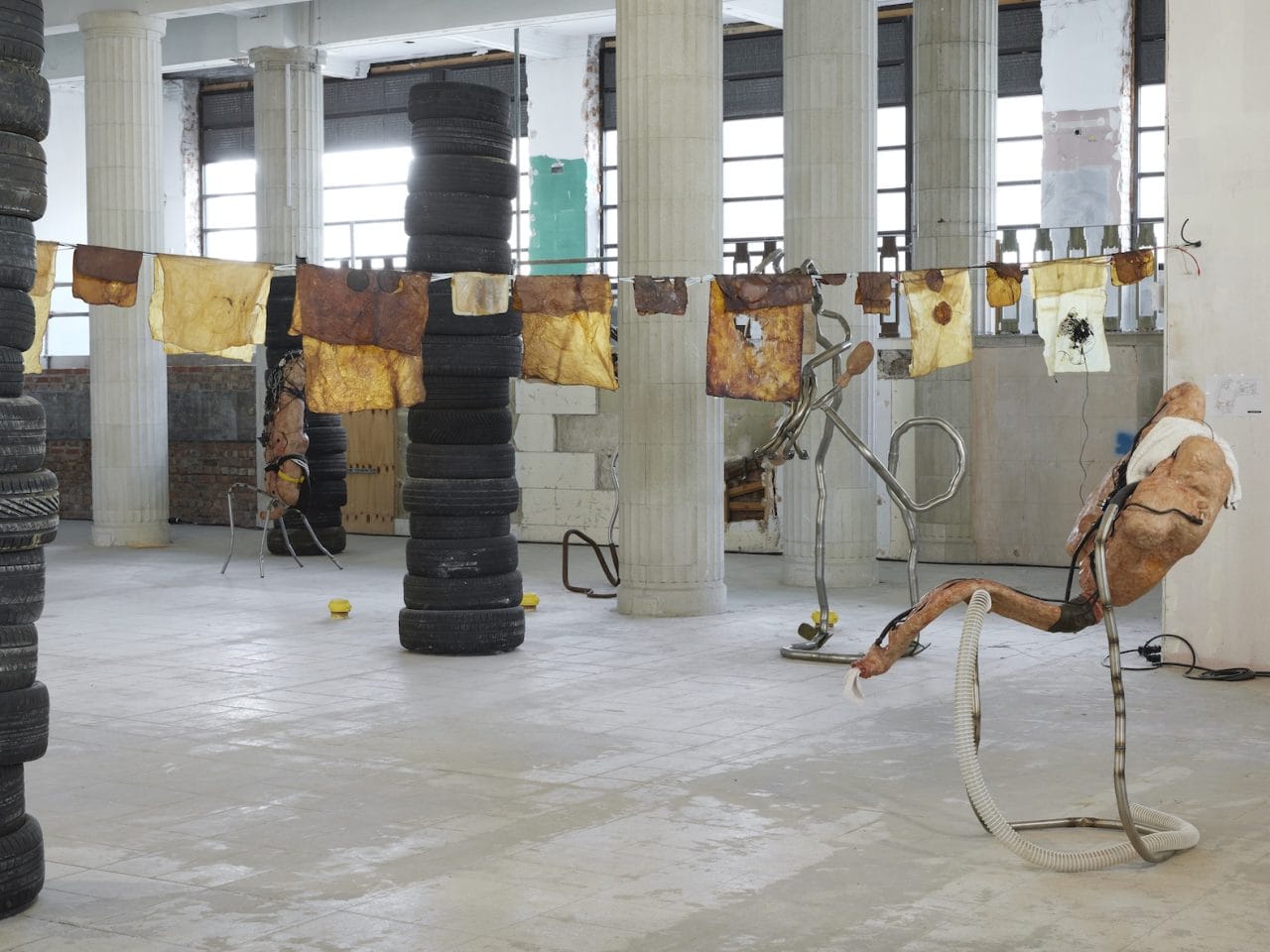 Mixed media sculptures made up of discarded objects, mostly car parts, and organic matter such as bioplastics. They resemble living bodily systems in their normal day-to-day functions. There are also stacks of used typres in the space