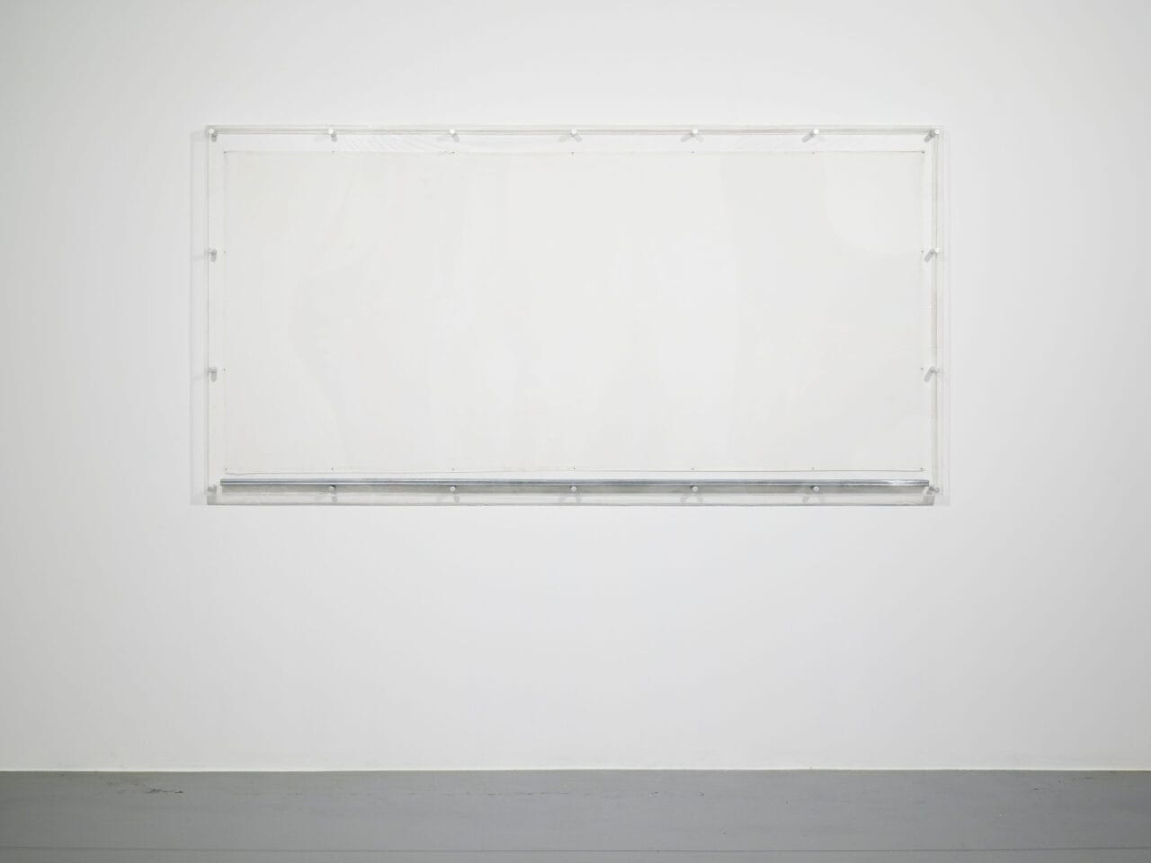 a white wall with plain white sheet of muslin fabric, boxed in with a glass⁠
