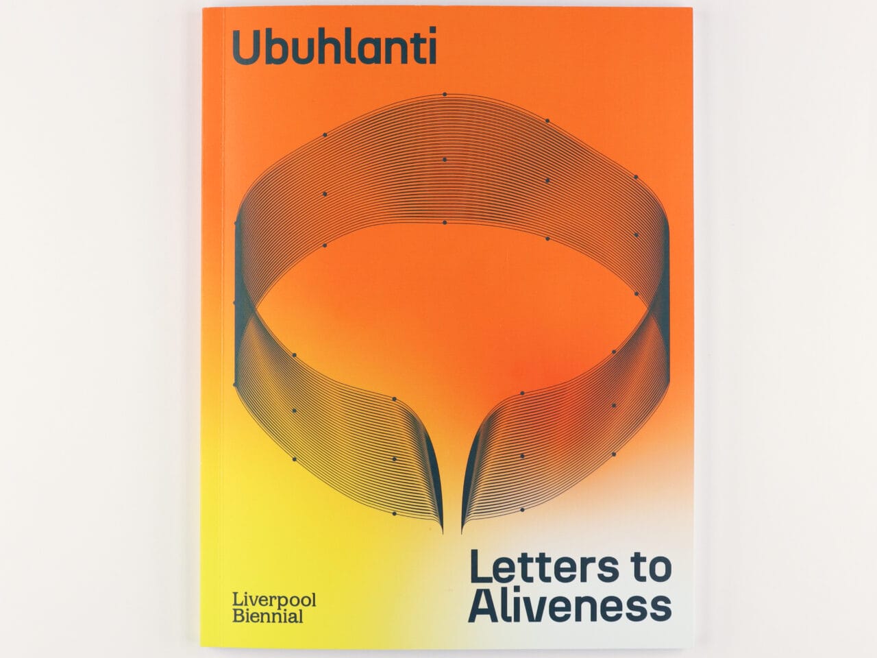 a orange and yellow book titled, Ubuhlanti letters to aliveness. There is a circular dark green graphic on the front page