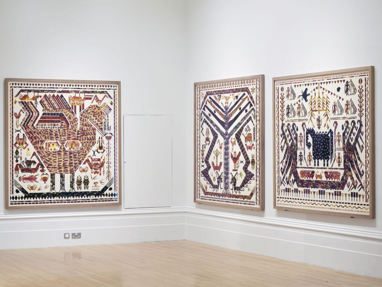 Three large canvases with various figurative shapes and patterns pictured across them, there are elements that are filled with tulip petals